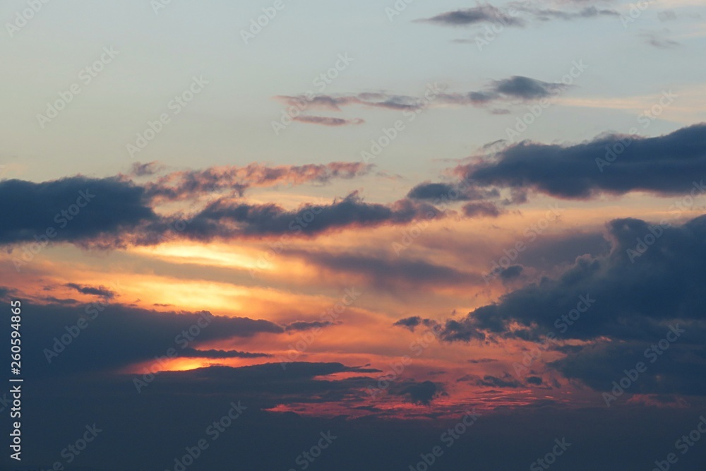 Beautiful dark dramatic clouds in the sky at sunset, natural background 