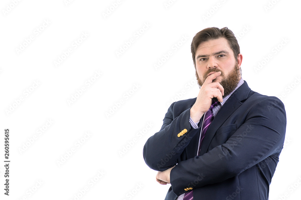 Portrait of a big handsome pensive bearded business man in a dark suit and a bright blue tie, isolated on white Portrait of a big handsome pensive bearded business man in a dark suit and a bright blue tie, isolated on white