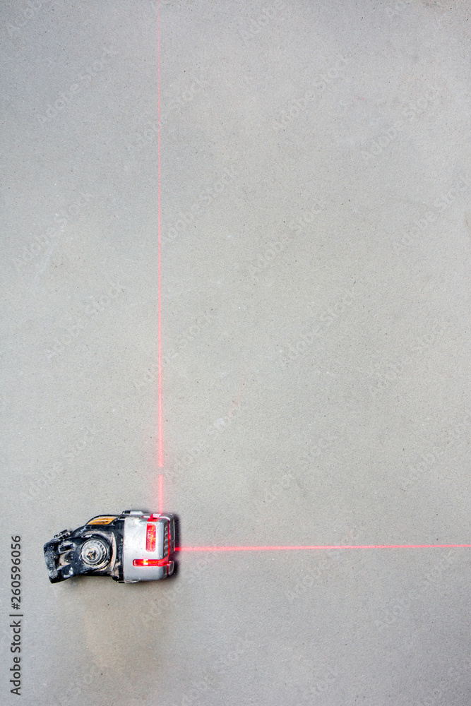 red laser tool for measure the distant on floor background red laser tool for measure the distant on floor background