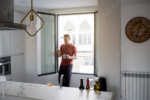 Man having breakfast with mobile phone