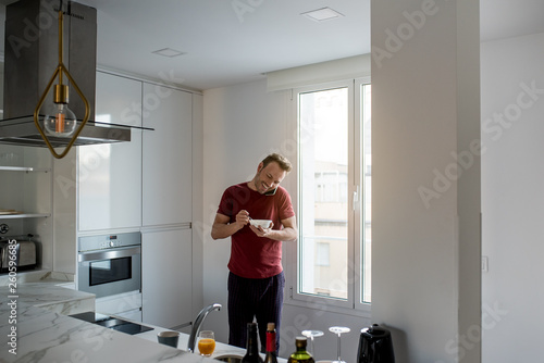 Man having breakfast with mobile phone