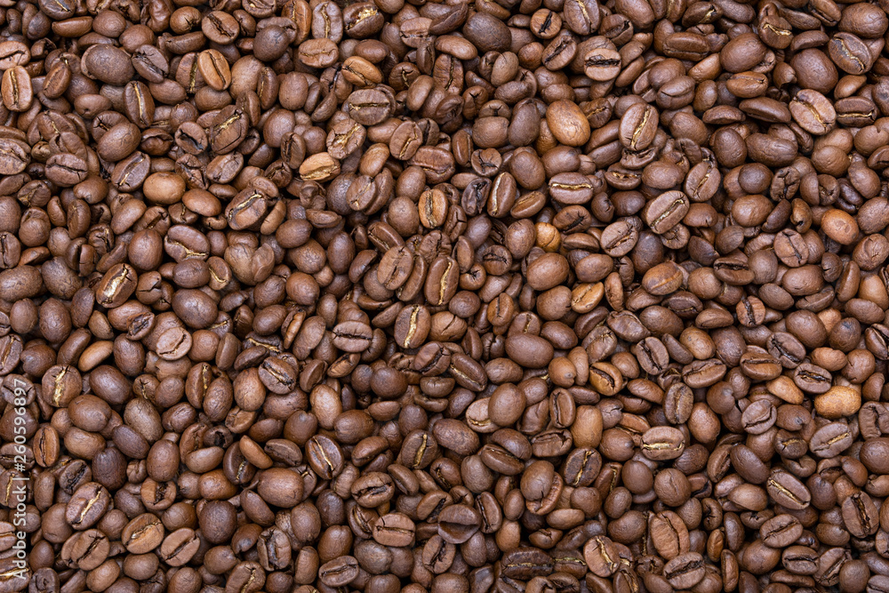 A lot of roasted fine coffee beans. Coffee beans background. Concept view. A lot of roasted fine coffee beans. Coffee beans background. Concept view.