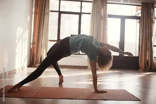girl athlete doing bridge / yoga, professional gymnast, stretching and yoga trainer