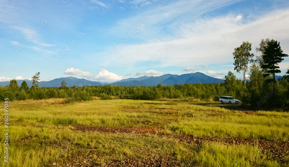 Panoramic view of the field, rocks and the sky. Lake Baikal, Russia. Panoramic view of the field, rocks and the sky. Lake Baikal, Russia.