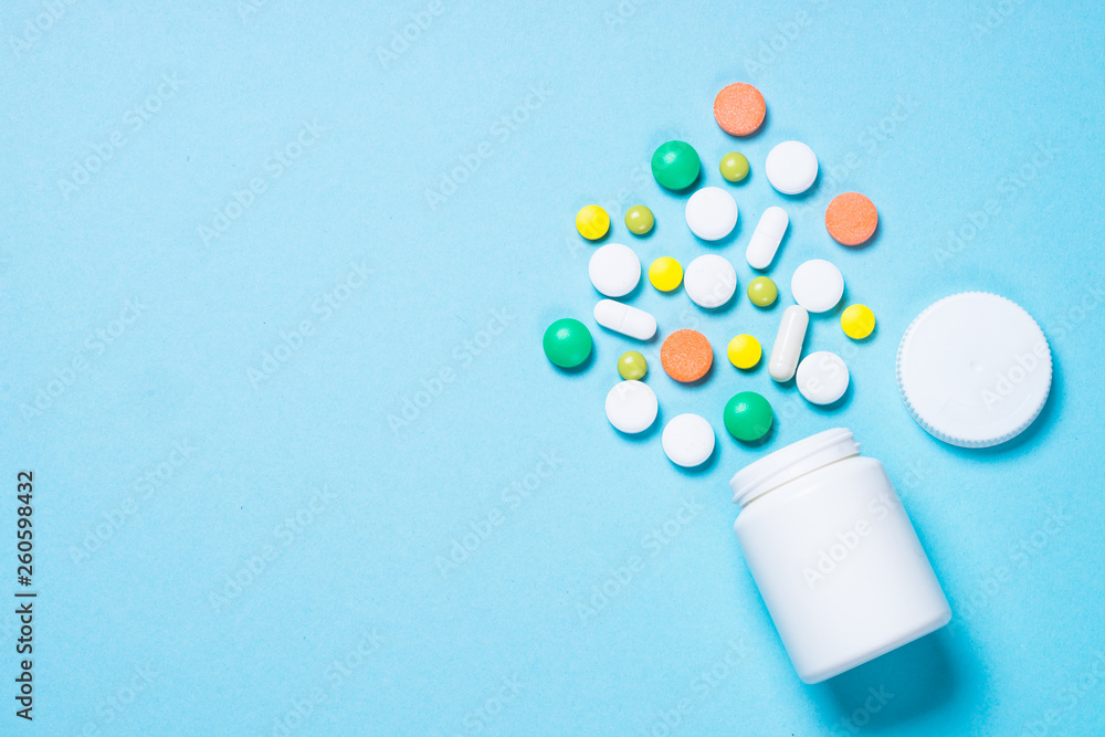 Pills, tablets and vitamin on blue Pills, tablets and vitamin on blue