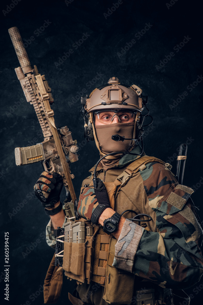 Elite unit, special forces soldier in camouflage uniform posing with assault rifle. Elite unit, special forces soldier in camouflage uniform posing with assault rifle.