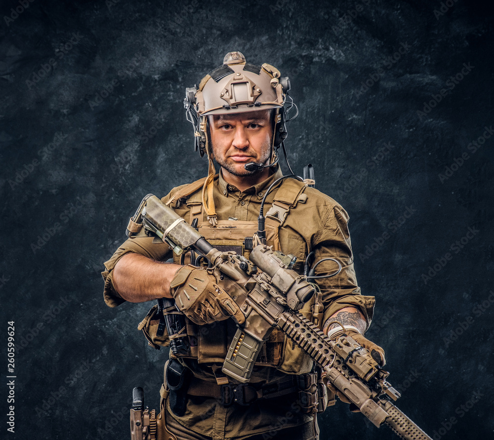 Elite unit, special forces soldier in camouflage uniform posing with assault rifle. Elite unit, special forces soldier in camouflage uniform posing with assault rifle.