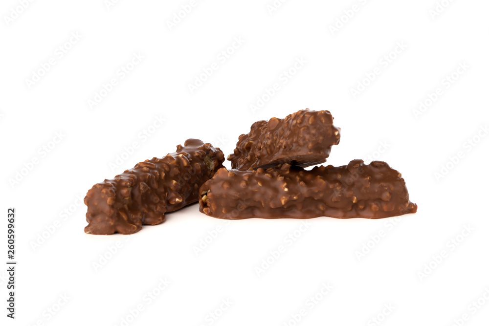 Chocolate bar on a white background. Candy with peanuts and raisins, caramel, puffed rice waffles, in chocolate isolated on white background. Chocolate bar on a white background. Candy with peanuts and raisins, caramel, puffed rice waffles, in chocolate isolated on white background.