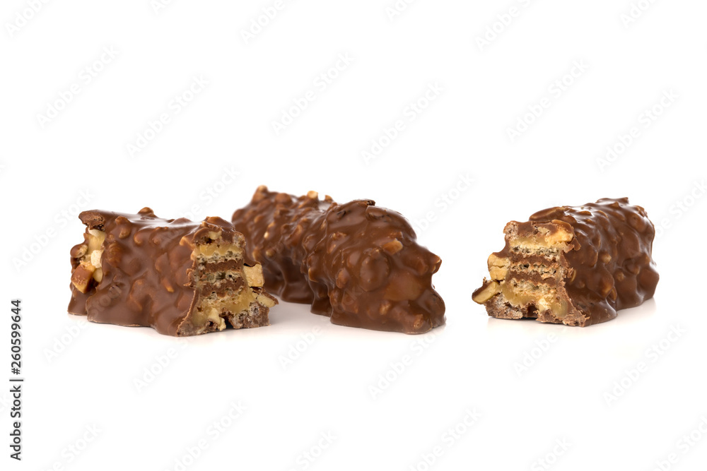 Chocolate bar on a white background. Candy with peanuts and raisins, caramel, puffed rice waffles, in chocolate isolated on white background.