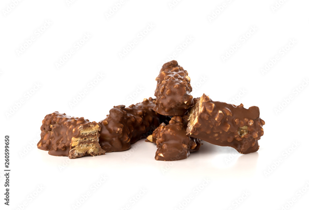 Chocolate bar on a white background. Candy with peanuts and raisins, caramel, puffed rice waffles, in chocolate isolated on white background. Chocolate bar on a white background. Candy with peanuts and raisins, caramel, puffed rice waffles, in chocolate isolated on white background.
