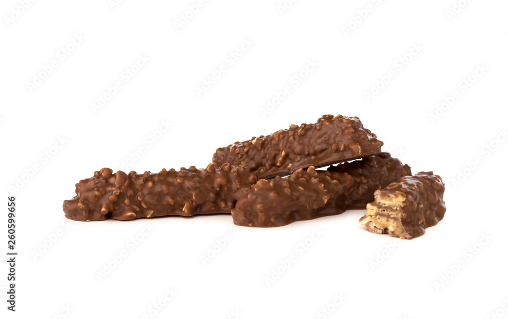 Chocolate bar on a white background. Candy with peanuts and raisins, caramel, puffed rice waffles, in chocolate isolated on white background. Chocolate bar on a white background. Candy with peanuts and raisins, caramel, puffed rice waffles, in chocolate isolated on white background.