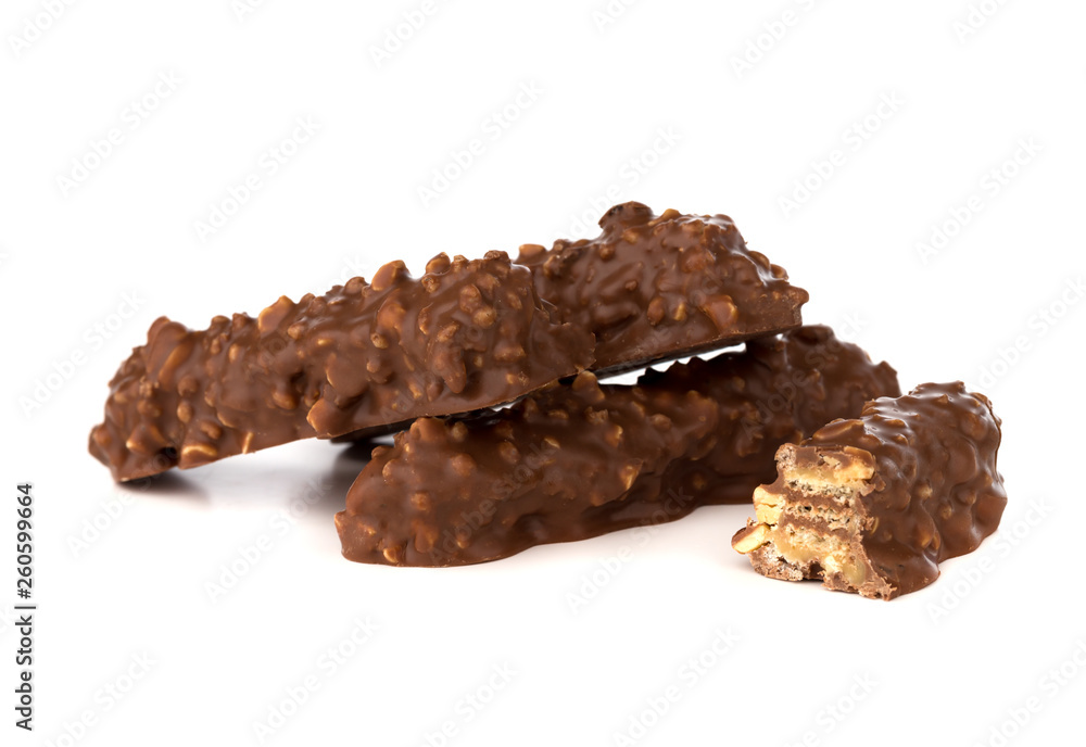 Chocolate bar on a white background. Candy with peanuts and raisins, caramel, puffed rice waffles, in chocolate isolated on white background. Chocolate bar on a white background. Candy with peanuts and raisins, caramel, puffed rice waffles, in chocolate isolated on white background.