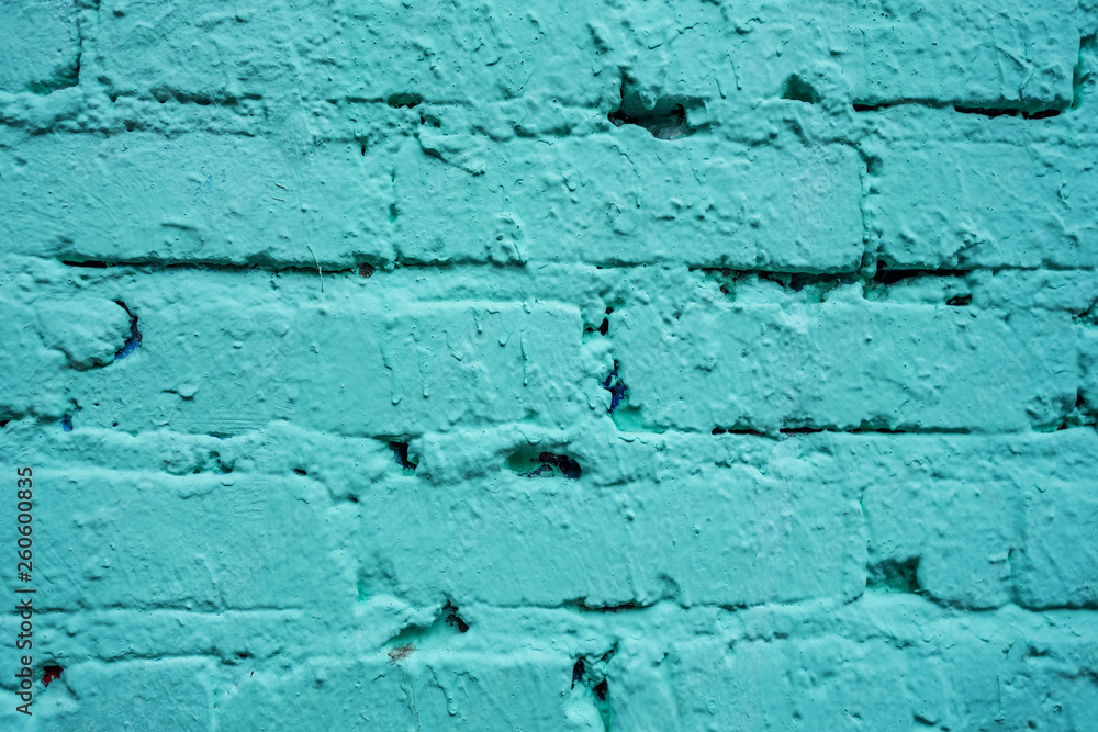 old brick wall painted in light turquoise