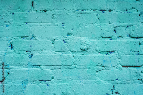 old brick wall painted in light turquoise