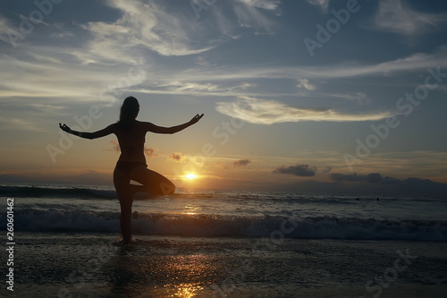 Fototapeta Naklejka Na Ścianę i Meble -  meditation and yoga on the beach / summer vacation concept health beauty, summer vacation yoga classes on the sea shore