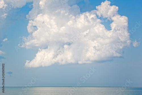 White cloud over the sea against a stormy sky