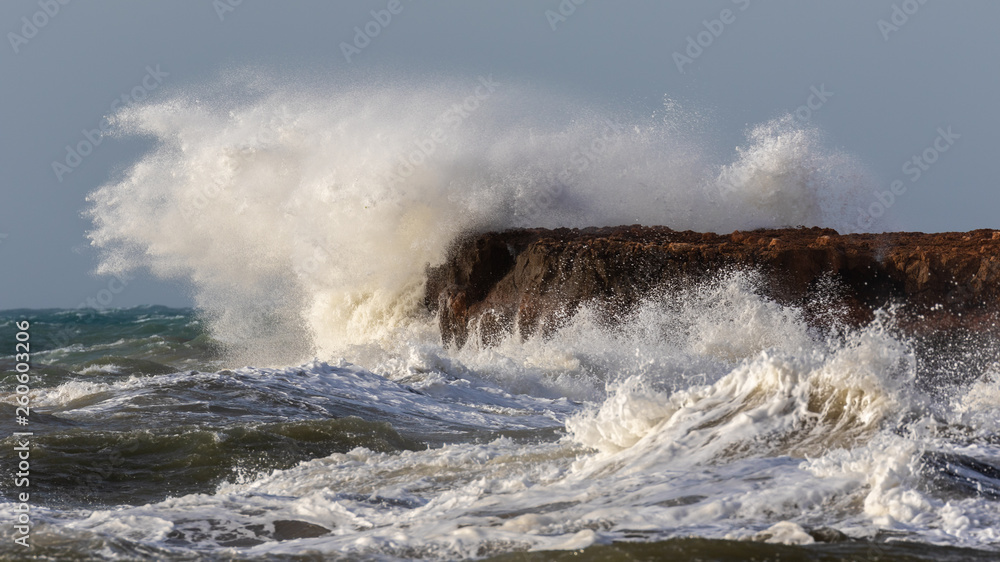 A big waves crashing on the big rocks on the coast of Torrevieja on Spain's Costa Blanca