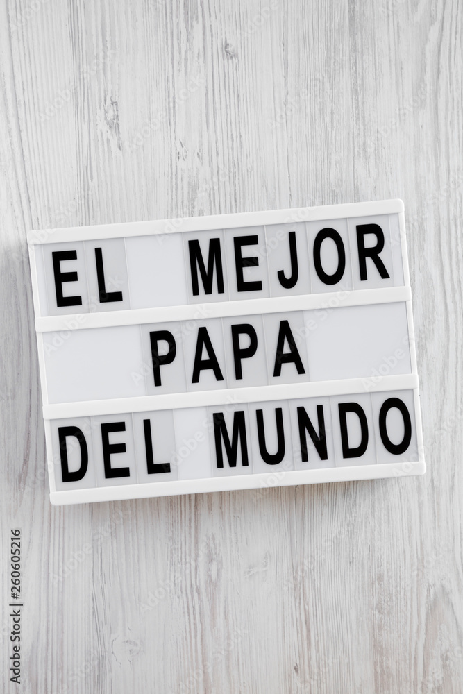 'El Mejor Papa Del Mundo' words on lightbox over white wooden surface, overhead view. Top view, from above, flat lay. Father's day. 'El Mejor Papa Del Mundo' words on lightbox over white wooden surface, overhead view. Top view, from above, flat lay. Father's day.