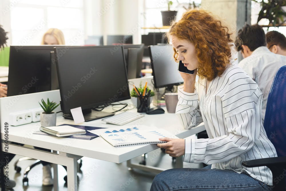 Young millennial woman discussing financial document with client Young millennial woman discussing financial document with client