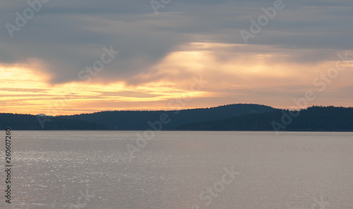 Stormy Sunset over Sea with Mountains