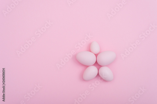 Spreaded Easter eggs on pink background
