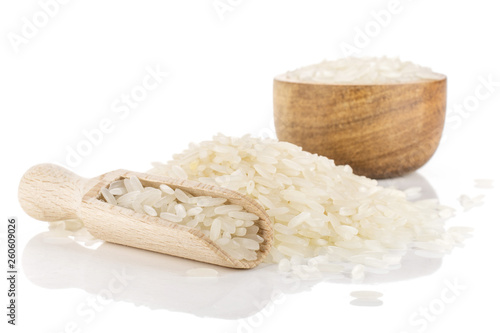 Lot of whole raw white jasmine rice grains in a wooden bowl isolated on white background