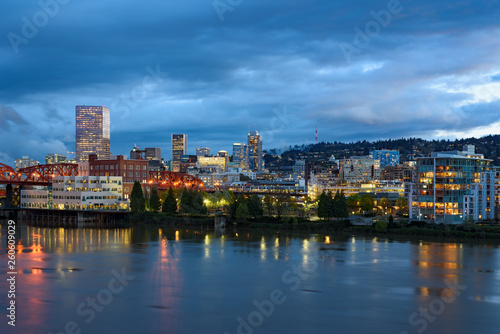 Evening twilight view of Portland, Oregon downtown from Willamette river bank