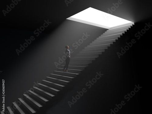 woman climbs the stairs from darkness to light photo