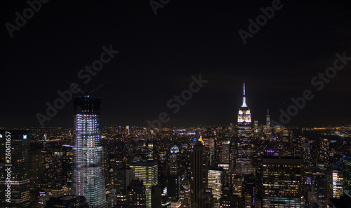 Night time aerial view of Manhattan in New York City showing the classic high rise buildings and city scape in the USA