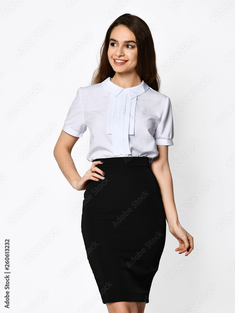 Young beautiful woman posing in light-dark office suit. Light blouse and  dark pencil skirt. Formal wear. Stock Photo | Adobe Stock