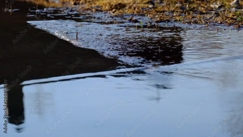 water flow over land with mud and grass water flow over land with mud and grass