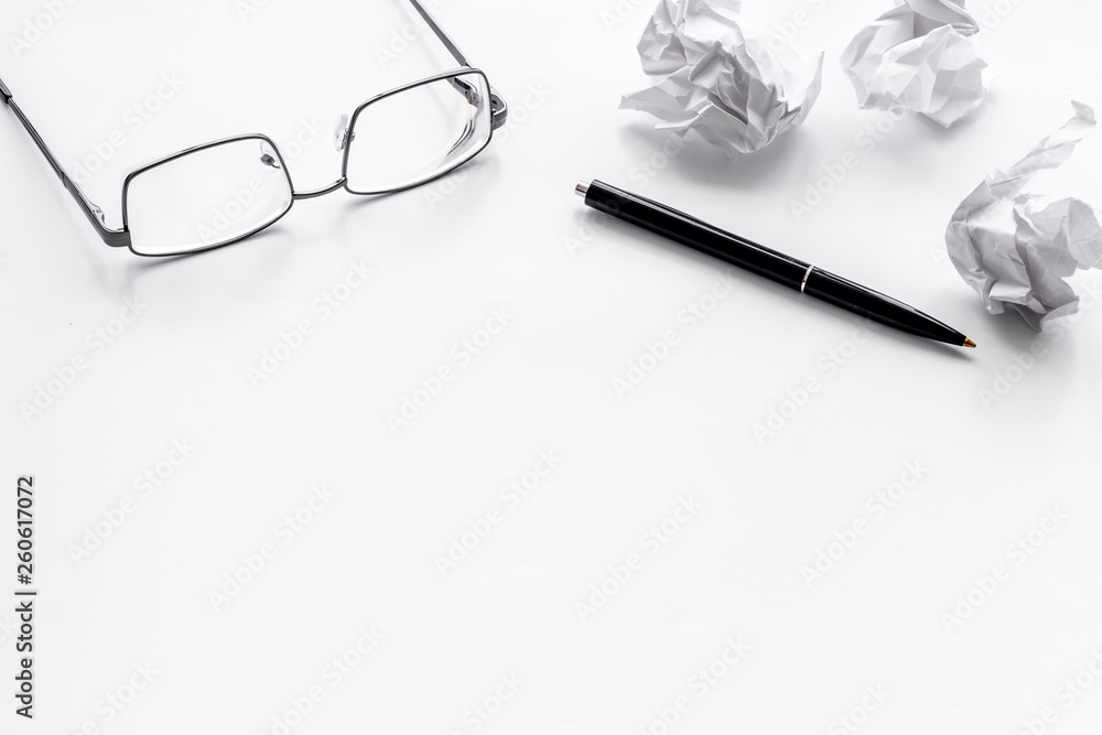 blogger office desk with glasses, pen and paper balls on white background copyspace blogger office desk with glasses, pen and paper balls on white background copyspace