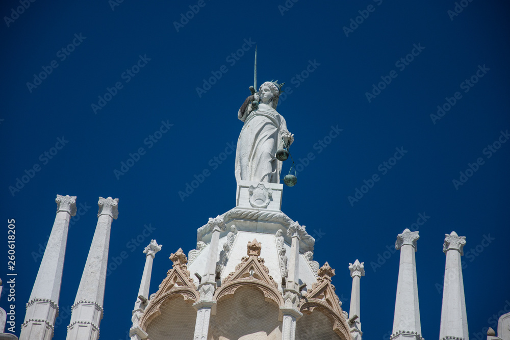 Goddess of Justice old statue at the top of Doge Palace in Venice, Italy,2019,march