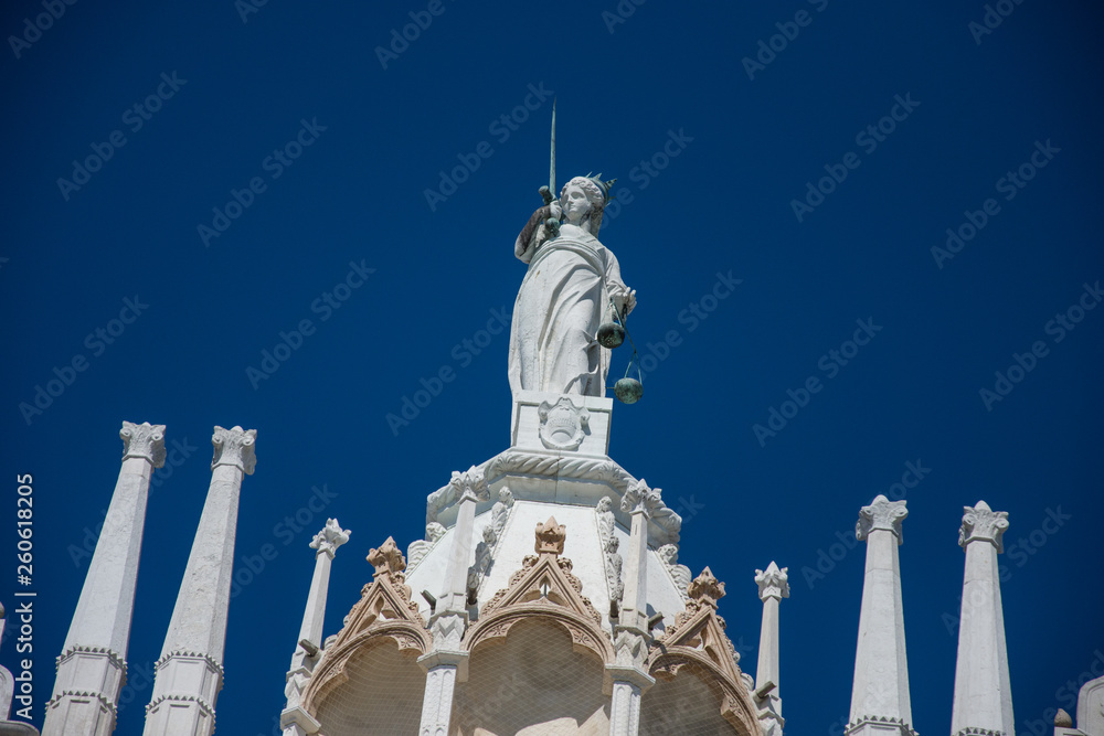 Goddess of Justice old statue at the top of Doge Palace in Venice, Italy,2019,march Goddess of Justice old statue at the top of Doge Palace in Venice, Italy,2019,march