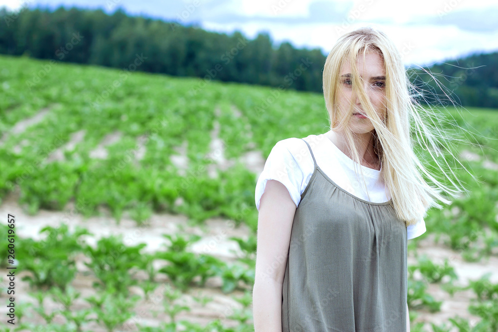 close-up portrait of a cute beautiful young blonde girl with freckles