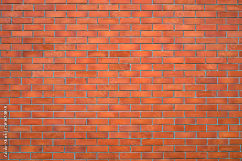 Red brick wall fragment background or brick layer building texture.