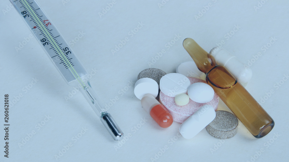 Pharmacy theme, tablets, pills capsule heap mix therapy drugs with medicine antibiotic and thermometer. Close up of capsules. Medicine background for medical concept. Pharmacy theme, tablets, pills capsule heap mix therapy drugs with medicine antibiotic and thermometer. Close up of capsules. Medicine background for medical concept.