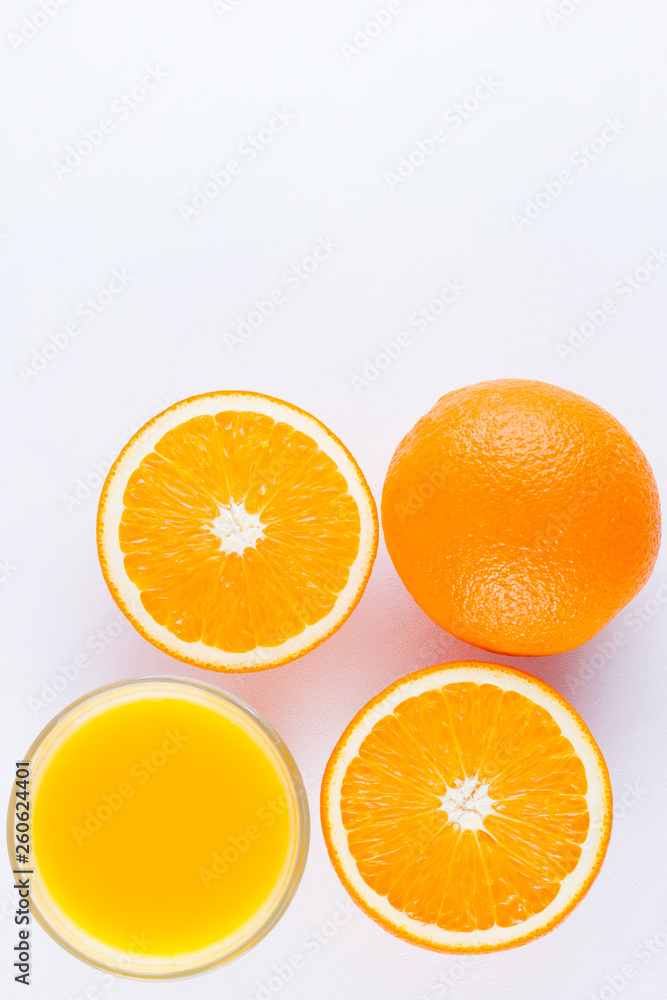 Orange fruits with juice, concept. Orange juice and halves of oranges on white background. Citrus for making juice. Whole and squeezed oranges and glass of juice Orange fruits with juice, concept. Orange juice and halves of oranges on white background. Citrus for making juice. Whole and squeezed oranges and glass of juice