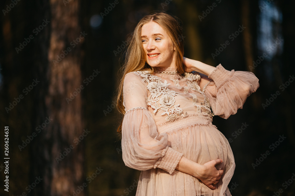 Beautiful portrait of a pregnant woman in the forest. Beautiful portrait of a pregnant woman in the forest.