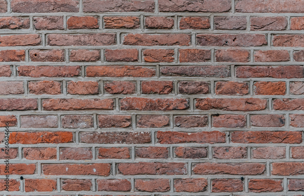 Fototapeta premium industrial red brick wall background in Europe. May be used in design and interiors.