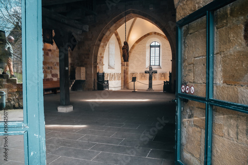 Catholic church interior with medieval walls and arch designed construction. Holy cross and gothic architecture