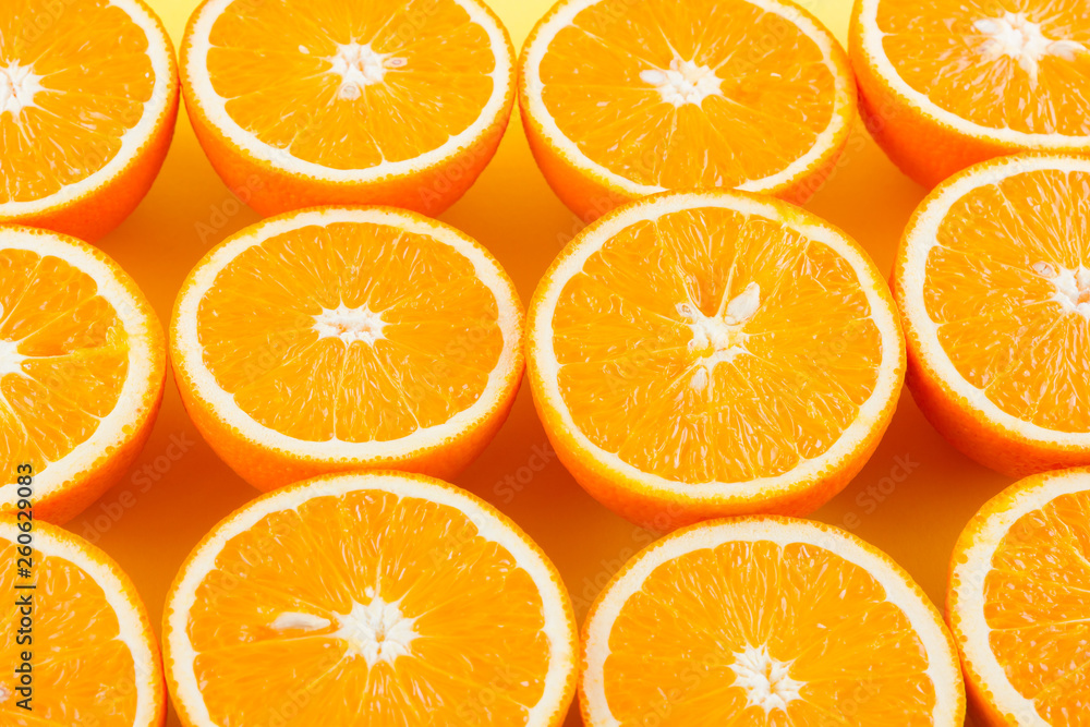 Cut halves of juicy orange on yellow background. Orange fruit, citrus minimal concept. Creative summer food minimalistic background. Top view, flat lay Cut halves of juicy orange on yellow background. Orange fruit, citrus minimal concept. Creative summer food minimalistic background. Top view, flat lay