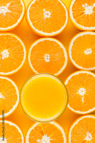 Cut halves of juicy orange on yellow background. Orange fruit  citrus minimal concept. Creative summer food minimalistic background. Top view  flat lay