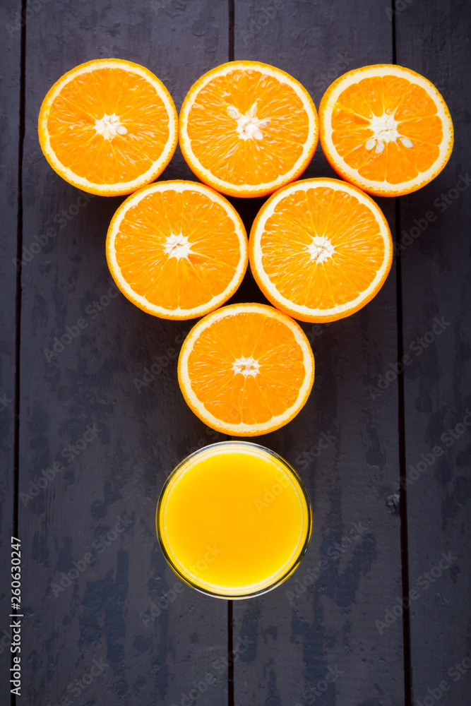 Oranges fruit on black wooden boards. Halves of juicy orange on black background. Orange fruit, citrus minimal concept. Top view, copy space Oranges fruit on black wooden boards. Halves of juicy orange on black background. Orange fruit, citrus minimal concept. Top view, copy space
