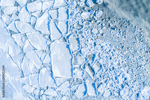 Ice floes above. Cracked ic...