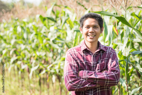 Asian farmer arms crossed in organic corn field, Thailand