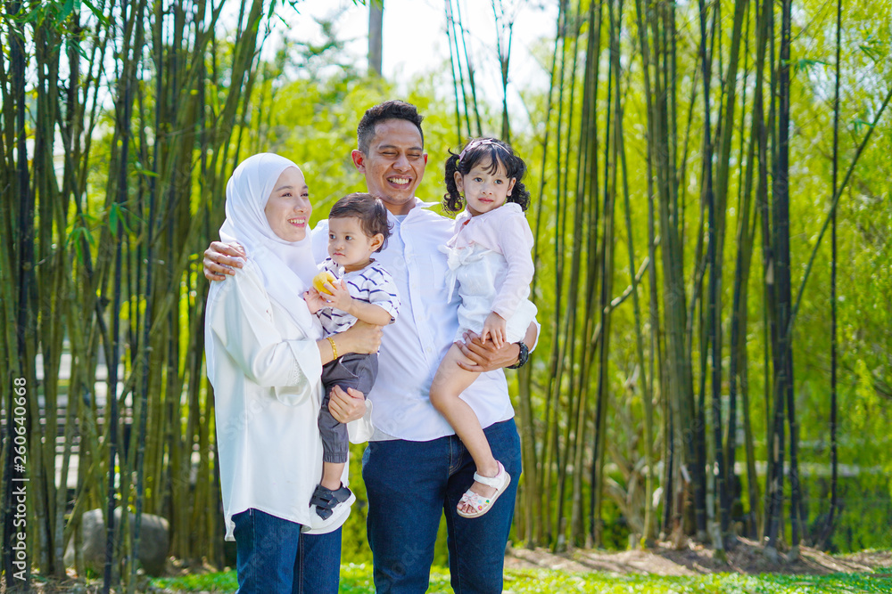 Fototapeta premium Happy family, spending time together, playing at park. Parenting, happy family concept. Selective focus