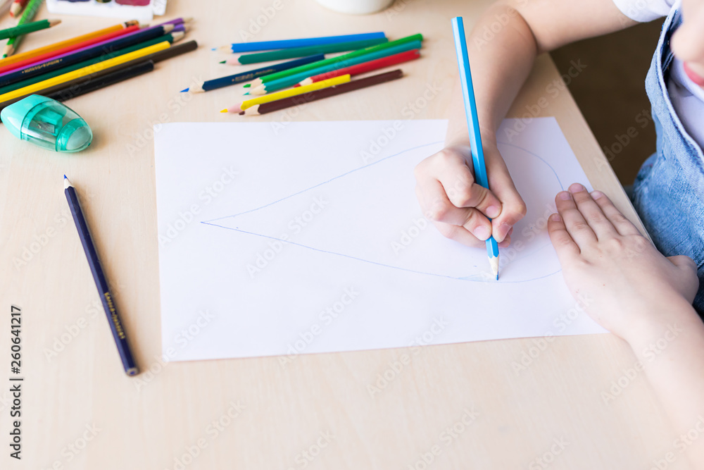 A little girl draws a drop of pure blue water with colored pencils. Concept of ecology and protection of the environment A little girl draws a drop of pure blue water with colored pencils. Concept of ecology and protection of the environment