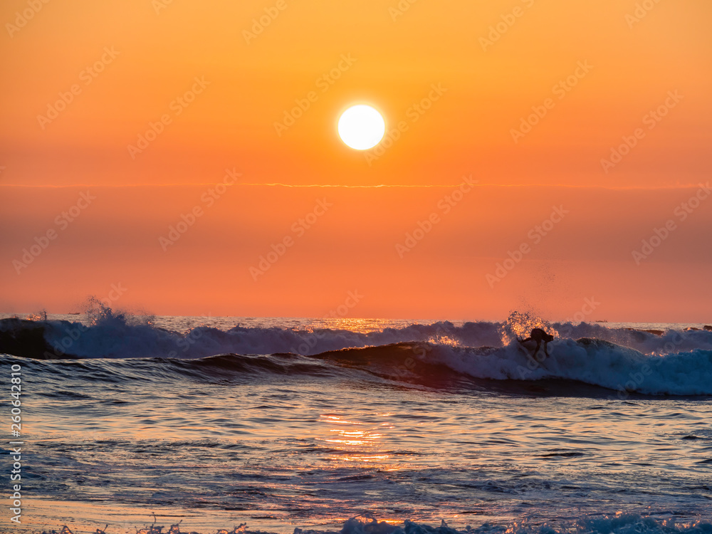 Surfers enjoying a beautiful sunset surf at Montanita Ecuador