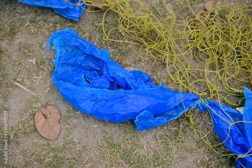 Waste Plastic packets are dumped on dirty soil ground